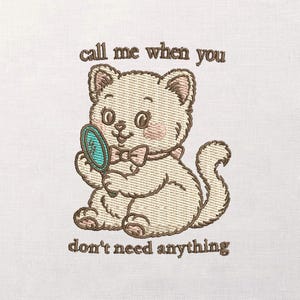 May include: Embroidered image of a cream-colored cat holding a teal mirror, wearing a pink bow tie and blush. The text "call me when you don't need anything" is embroidered above and below the cat.