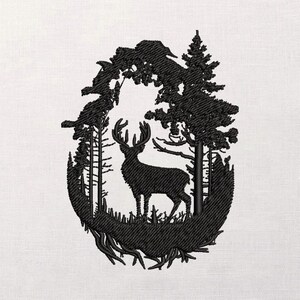 May include: Black embroidered design of a deer standing in a forest scene, framed within an oval shape. The detailed artwork features trees, grass, and the deer's antlers, all rendered in a textured stitch on a white background.