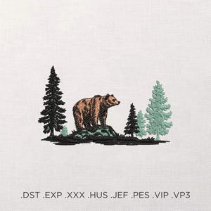 May include: Embroidered design of a brown bear on a rock, with evergreen trees in green and black. The design is set against a white background. The file formats .DST .EXP .XXX .HUS .JEF .PES .VIP .VP3 are listed at the bottom.
