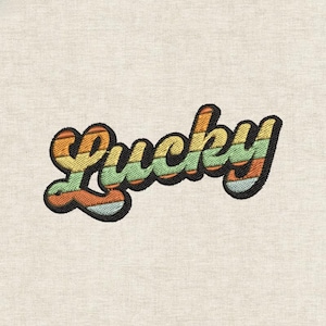 May include: Embroidered patch featuring the word "Lucky" in a retro font. The text is in a gradient of orange, yellow, green, and blue stripes, outlined in black. The patch is on a beige fabric background.