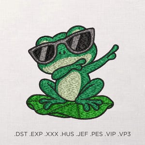 May include: An embroidery design featuring a green frog wearing grey sunglasses and performing a dab pose while sitting on a green lily pad. The text below the frog reads .DST .EXP .XXX .HUS .JEF .PES .VIP .VP3, indicating various file formats.