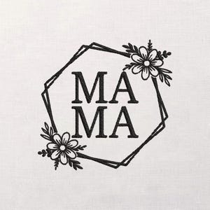 May include: Black embroidered design on a white background. The word "MAMA" is centered within a black geometric frame, with floral accents at the top and bottom. The design is simple and elegant.