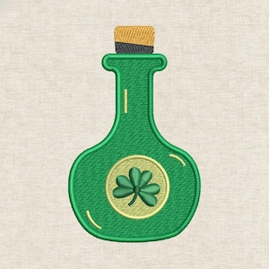 May include: Green bottle with a cork stopper, featuring a shamrock emblem. The bottle has a rounded base and a narrow neck. The shamrock is in a gold circle. The cork is tan and black.