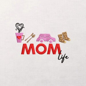 May include: Embroidered design featuring a pink coffee cup with a heart, spoon and fork, a pink car, and socks. The word "MOM" is in red, with "life" in black script. The design is on a white background.