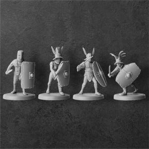 May include: Four miniature plastic figures of gladiators, each with a different helmet and shield, standing on a gray surface.