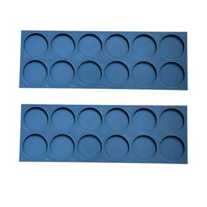 May include: Two rows of blue plastic paint pot holders. Each row has 8 circular indentations for holding paint pots.