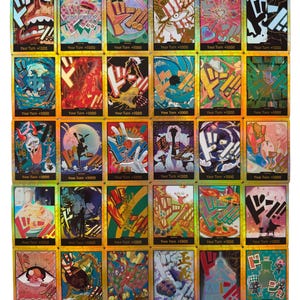 May include: A collection of trading cards with holographic foil accents. Each card features colorful illustrations and the text "Your Turn +1000". The cards showcase various character designs and graphic elements, with a gold border.