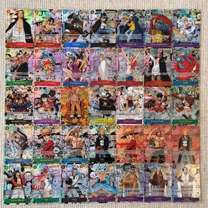 May include: A collection of thirty-five One Piece trading cards arranged in a grid, featuring various characters like Luffy, Zoro, and Shanks. Each card displays colorful anime-style illustrations, character names, and game statistics with a holographic finish.
