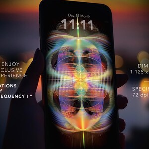 May include: A smartphone displays a vibrant, abstract digital artwork with a colorful, symmetrical design. The screen shows the time 11:11. Text on the image reads "Vibrations of Quantum Frequency I". The image dimensions are 1125 x 2436 pixels.