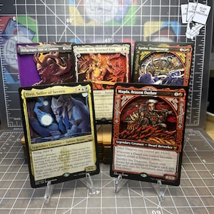 May include: Five 3D shadowbox trading cards featuring fantasy characters. The cards include Shilgengar, Sire of Famine, Kenrith, the Returned King, Kardur, Doomscourge, Tivit, Seller of Secrets, and Magda, Brazen Outlaw, displayed on clear stands.