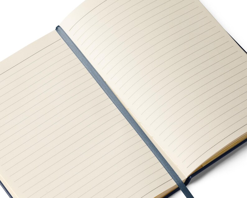 May include: A blank, lined notebook with a blue spine and a blue ribbon bookmark. The notebook is open to a fresh, blank page.