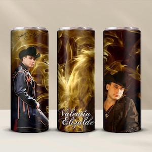 May include: Three stainless steel tumblers with a black and gold design. The tumblers feature a photo of a man wearing a cowboy hat and a black leather jacket. The text "Valentin Elizalde" is printed on the middle tumbler.