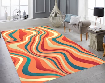 May include: Abstract area rug with wavy lines in shades of orange, red, yellow, and teal. The rug is laid out on a wood floor in a living room setting.