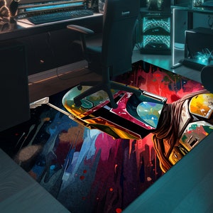 May include: A colorful, abstract rug featuring a stylized image of Boba Fett's helmet. The rug has splashes of blue, red, yellow, and green paint.