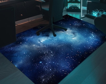 May include: A dark blue galaxy rug with a white nebula and white stars. The rug is on a wooden floor.