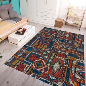 May include: A colorful area rug with a geometric pattern in shades of blue, red, yellow, and white. The rug is made of a soft, durable material and is perfect for adding a touch of style to any room.