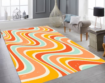 May include: A colorful abstract rug with wavy lines in shades of orange, yellow, blue, and white. The rug has a vintage, retro style.