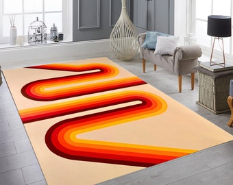 May include: A retro-style area rug with a cream background and a colorful abstract design of curved lines in shades of red, orange, and yellow.