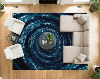 May include: Overhead view of a living room with a large blue and white patterned rug. The rug features a swirling water design. Two white armchairs, a sectional sofa, and a glass coffee table are on the rug.