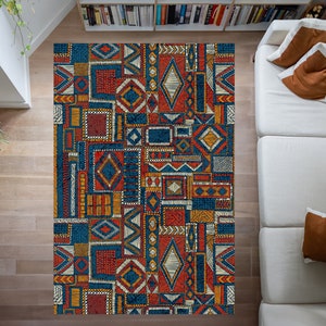 May include: A colorful rug with a geometric pattern in shades of blue, orange, yellow, and red. The rug is made up of a variety of different shapes and sizes, creating a visually interesting design.