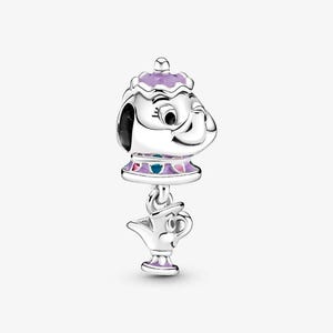 May include: A silver charm depicting a teapot character with a purple lid and accents. A smaller teapot charm hangs below. The letters "KA" are visible in the upper left corner.