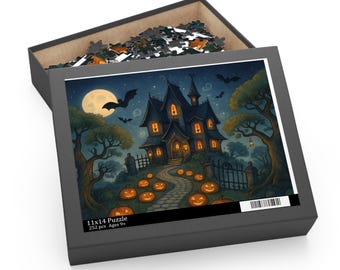 May include: A Halloween jigsaw puzzle in a black box. The image shows a spooky haunted house with glowing windows, a full moon, bats, and jack-o'-lanterns. The box is labelled "11x14 Puzzle" and "252 pcs Ages 9+". The puzzle measures 28 x 36 cm.