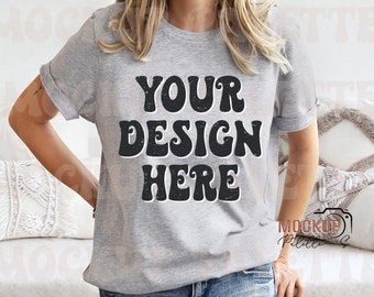 May include: A gray t-shirt with the text "YOUR DESIGN HERE" in a retro font.