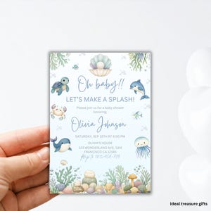 May include: A baby shower invitation with an aquatic theme. The invitation features illustrations of sea creatures like a turtle, dolphin, and jellyfish. Text includes "Oh baby!!" and "Let's make a splash!" with event details.