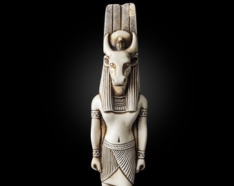 May include: White figurine of an Egyptian god with a bull's head, wearing a crown and a necklace. The figurine is standing with its arms at its sides.