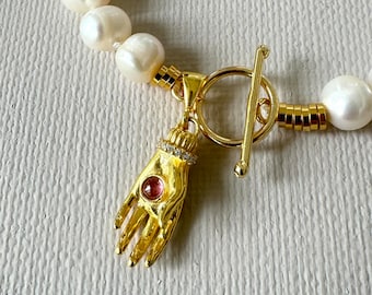 Chic, short, big pearl necklace with gold filled silver hand pendant embellished with tourmaline and zirconium stones and toggle closure