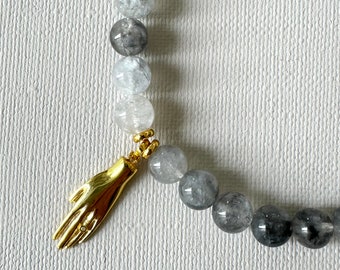 Grey, shiny labradorite stones necklace with a yellow gold filled on sterling silver charm in the shape of Hamsa