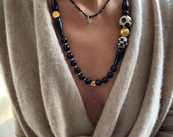Mix of onyx and hand painted ceramics in different sizes and shapes, combined with with gold filled (on sterling silver) spacers