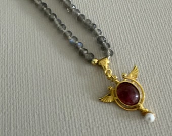 Grey labradorite stones necklace that ends with a yellow gold filled on sterling silver charm