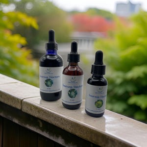 May include: Three glass bottles with dropper tops containing Soursop Tincture. The bottles are labeled with the text "Botanical" and "Soursop Tincture". The bottles are 4 oz, 2 oz, and 1 oz.