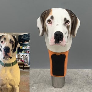May include: A custom-made dog head bottle stopper, featuring a white and brown dog with black spots. The stopper is made of a light brown material with a black and orange base.
