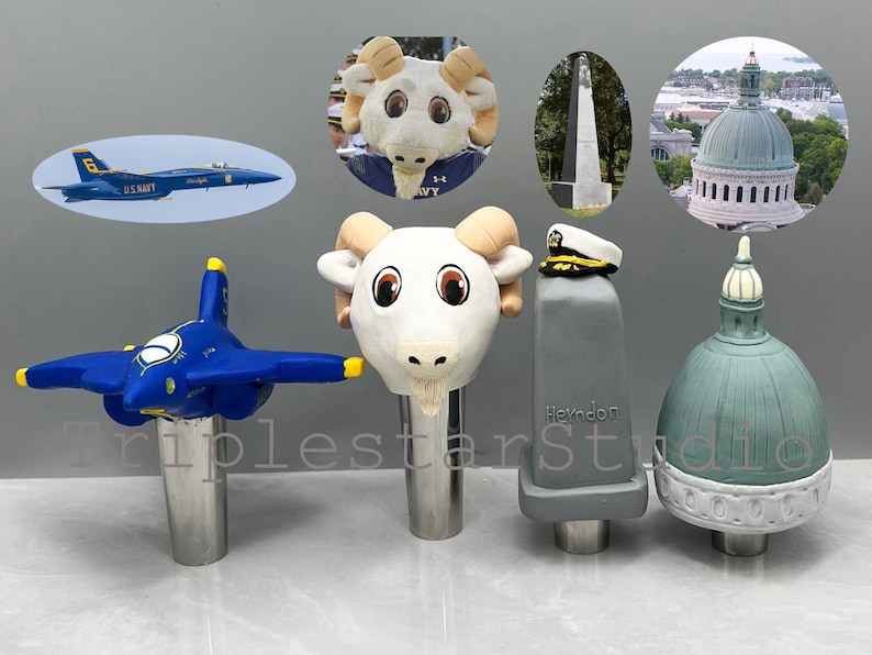 May include: Four different beer tap handles. The first is a blue and yellow airplane, the second is a white ram head, the third is a gray block with the word "Heydon" on it, and the fourth is a green dome with a white top.