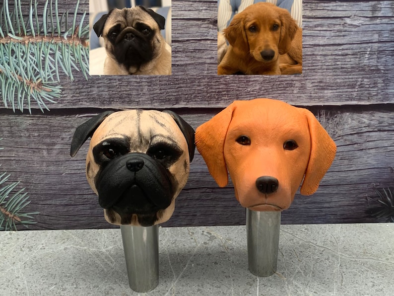 May include: Two ceramic dog head bottle stoppers. One is a tan pug with black eyes and nose. The other is an orange labrador retriever with brown eyes and nose.