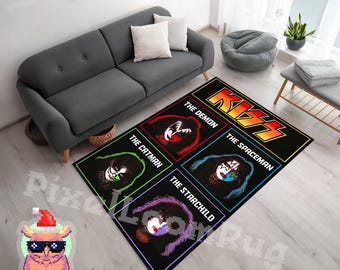 May include: A rectangular area rug featuring the KISS logo and four individual portraits of band members labeled The Demon, The Catman, The Spaceman, and The Starchild. Each portrait is framed in a colored border on a black background.