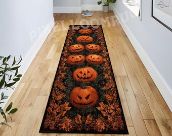 May include: A long rectangular runner rug featuring a repeating pattern of carved orange jack-o'-lanterns and dark autumn leaves on a black background. The design displays multiple pumpkins of varying sizes arranged in a vertical row along the center.