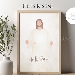 May include: A digital art print featuring a watercolor illustration of Jesus Christ in a white robe with the text "He Is Risen!" in brown lettering.