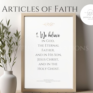 May include: A framed print with a beige background and black text. The text reads "1. We believe in God, the Eternal Father, and in His Son, Jesus Christ, and in the Holy Ghost." The print is titled "Articles of Faith".