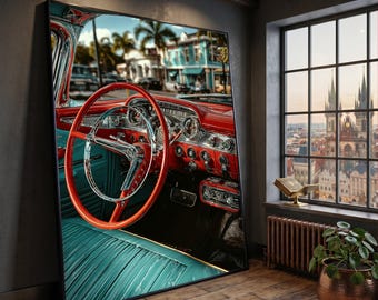 May include: A framed print showcasing the interior of a vintage car. The image highlights a red dashboard and steering wheel, set against teal upholstery. The car's interior is richly detailed, with chrome elements and a view of a tropical street scene visible.