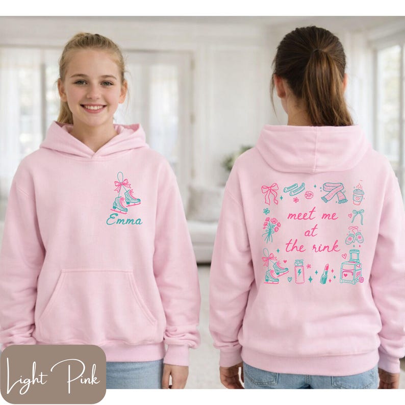 May include: Light pink hoodie with a front pocket and a hood. The front features a teal and pink ice skate design with the name "Emma". The back has a "meet me at the rink" design with ice skates, flowers, and other graphics.