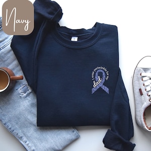 May include: Navy blue sweatshirt with a purple ribbon and the text "I wear periwinkle for my dad".
