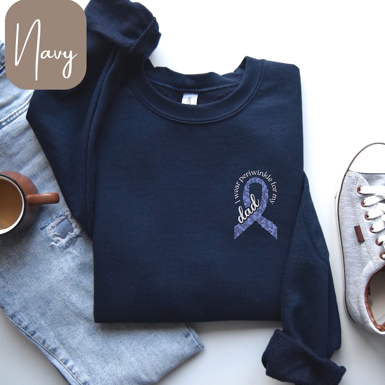 May include: Navy blue sweatshirt with a purple ribbon and the text "I wear periwinkle for my dad".