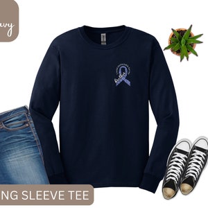 May include: Navy blue long-sleeve t-shirt with a purple ribbon and the text "I wear purple for my brother".