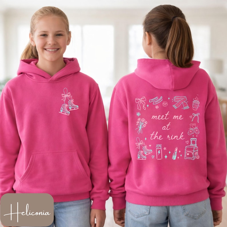 May include: A magenta hoodie with a front pocket and hood. The front features a small graphic of ice skates. The back of the hoodie has the phrase "meet me at the rink" with various ice skating-themed illustrations.