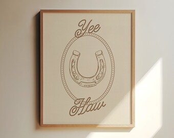 May include: A brown framed print with the text "Yee Haw" and a drawing of a horseshoe in a circle.