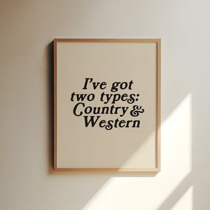 May include: A framed print with a white background and black text that reads "I've got two types: Country & Western".