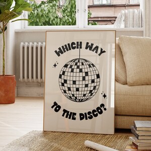 May include: A black and white poster with the text "Which Way To The Disco?" and a disco ball graphic.